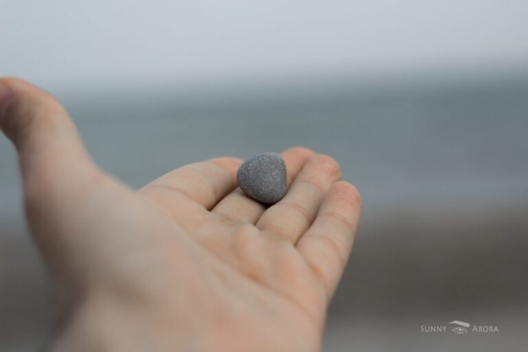 close up of hand with a stone on its fingers