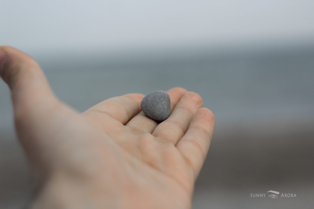 close up of hand with a stone on its fingers